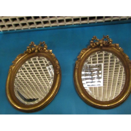 162 - Pair of Gilded Oval Form Wall Mirrors with Upper Ribbon Motif Decoration Each Approximately 22 Inche... 