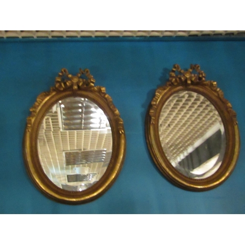 162 - Pair of Gilded Oval Form Wall Mirrors with Upper Ribbon Motif Decoration Each Approximately 22 Inche... 