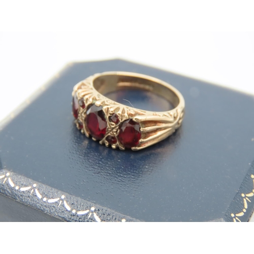 395 - Garnet Three Stone Ring Mounted on 9 Carat Yellow Gold Band Attractively Chased and Detailed Ring Si... 