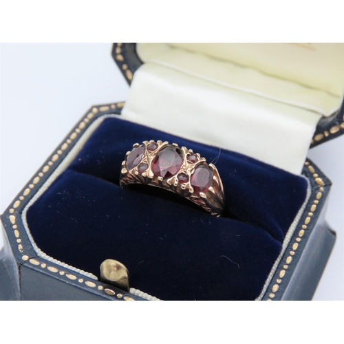 395 - Garnet Three Stone Ring Mounted on 9 Carat Yellow Gold Band Attractively Chased and Detailed Ring Si... 