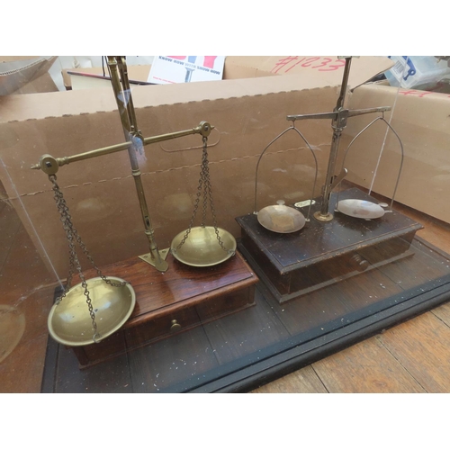 1240 - Two Sets of Balance Scales Contained in Acrylic Display Case Measuring Approximately 23 Inches Wide ... 