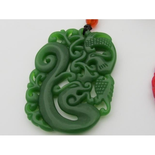 596 - Selection of Chinese Pendants in Jade and Coral Colourings with Tibetan Silver Elephant