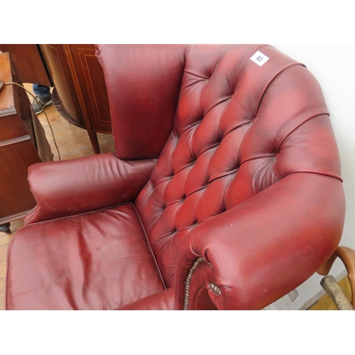 83 - Burgundy Chesterfield Wing Back Arm Chair Approximately 42 Inches Tall x 32 Wide