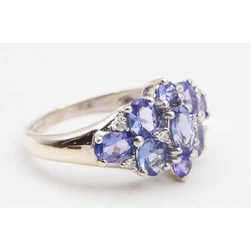 85 - Tanzanite Ladies Cluster Ring Mounted on 9 Carat White Gold Ring Size H and a Half