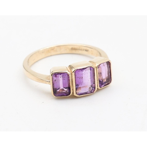 135 - Ladies 9 Carat Yellow Gold Three Stone Amethyst Ring Size O