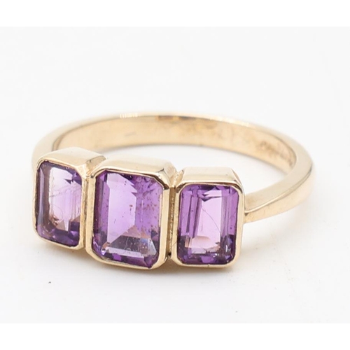 135 - Ladies 9 Carat Yellow Gold Three Stone Amethyst Ring Size O