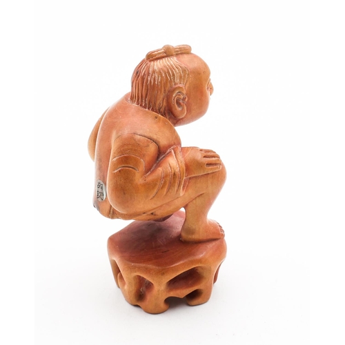 724 - Carved Figure of Squatting Man