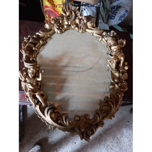 961 - Oval Gilded Mirror with Cherub Motifs Approximately 22 Inches High