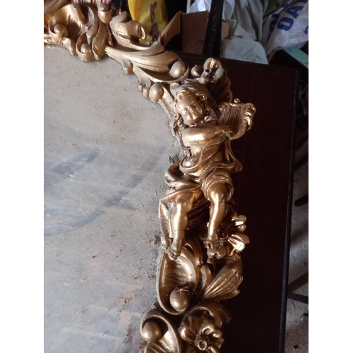 961 - Oval Gilded Mirror with Cherub Motifs Approximately 22 Inches High