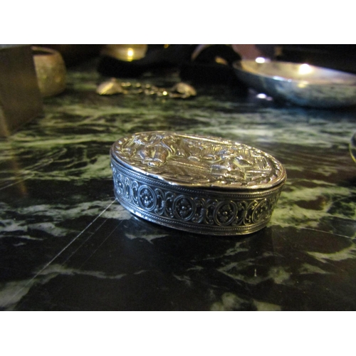 1190 - Silver Oval Form Pill Box Hinged Cover Embossed Figural Decoration