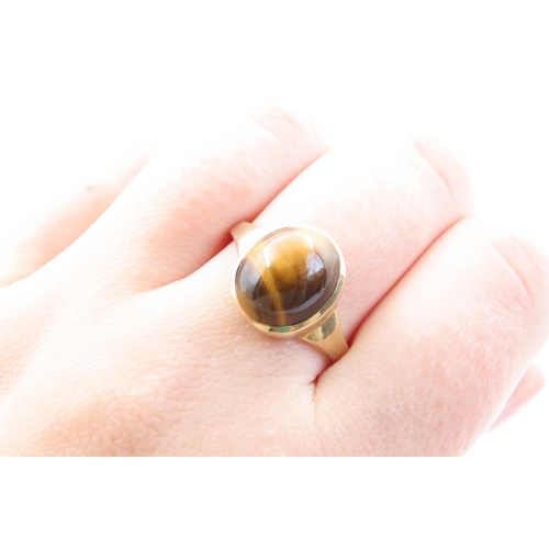 11 - Tigers Eye Solitaire Ladies Ring Mounted on 9 Carat Yellow Gold Band Ring Size V