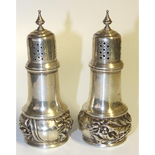 710 - Pair of Silver Salt and Peppers Emboss Decoration Upper Finial Motifs