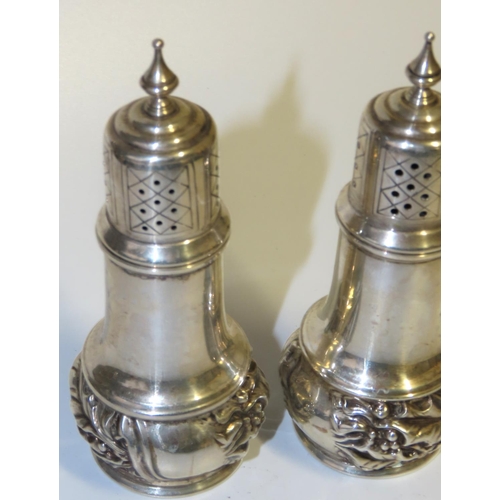 710 - Pair of Silver Salt and Peppers Emboss Decoration Upper Finial Motifs