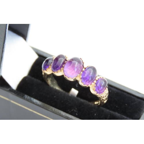 Amethyst Five Stone Ladies Ring Mounted on 9 Carat Yellow Gold Band Ring Size O