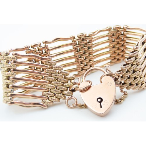 1290 - 9 Carat Rose Gold Seven Bar Ladies Bracelet Attractively Detailed with Padlock Motif Clasp and Safet... 