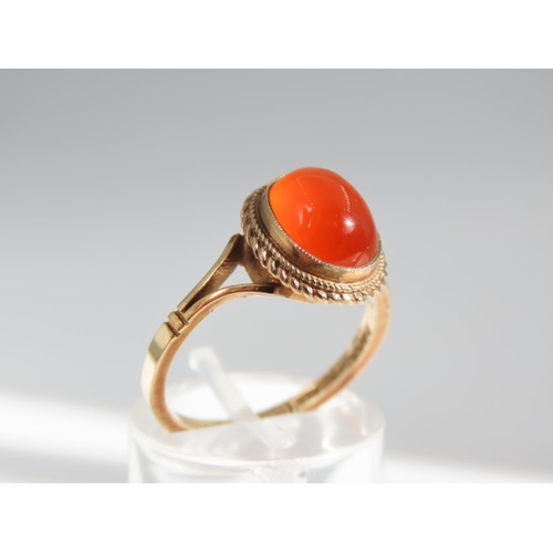 109 - Cabochon Oval Cut Red Gemstone Ring Mounted on 9 Carat Yellow Gold Band Basset Set Ring Size O