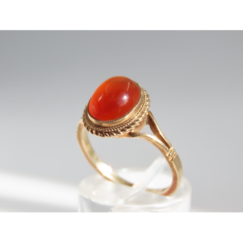 109 - Cabochon Oval Cut Red Gemstone Ring Mounted on 9 Carat Yellow Gold Band Basset Set Ring Size O