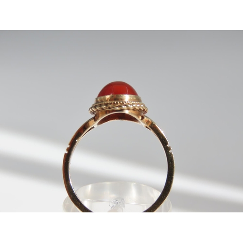 109 - Cabochon Oval Cut Red Gemstone Ring Mounted on 9 Carat Yellow Gold Band Basset Set Ring Size O