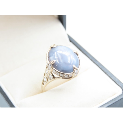 16 - Star Sapphire Centre Stone Ring Surrounded with Diamonds Four Claw Setting Mounted on 18 Carat Yello... 