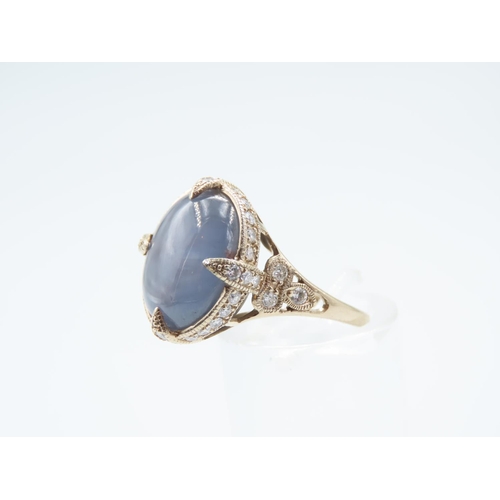 16 - Star Sapphire Centre Stone Ring Surrounded with Diamonds Four Claw Setting Mounted on 18 Carat Yello... 