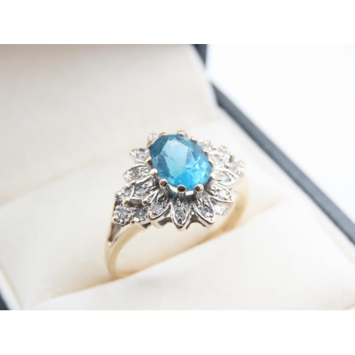 214 - Blue Topaz and Diamond Ladies Cluster Ring Mounted on 9 Carat Yellow Gold Band Ring Size Q