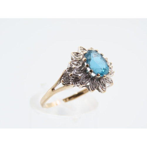 214 - Blue Topaz and Diamond Ladies Cluster Ring Mounted on 9 Carat Yellow Gold Band Ring Size Q