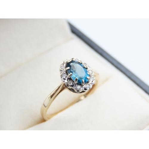 221 - Blue Topaz and Diamond Ladies Cluster Ring Mounted on 9 Carat Yellow Gold Band Ring Size N