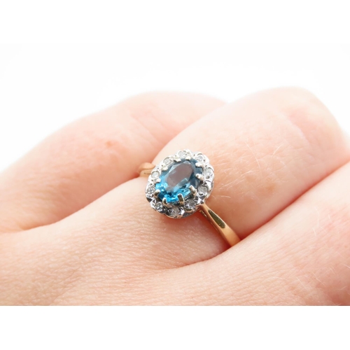 221 - Blue Topaz and Diamond Ladies Cluster Ring Mounted on 9 Carat Yellow Gold Band Ring Size N