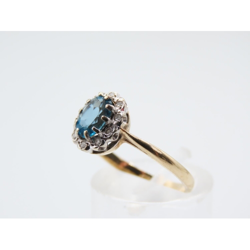 221 - Blue Topaz and Diamond Ladies Cluster Ring Mounted on 9 Carat Yellow Gold Band Ring Size N