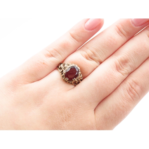 42 - 9 Carat Yellow Gold Red Garnet Set Centre Stone Ring Detailing to Shoulders Ring Size N