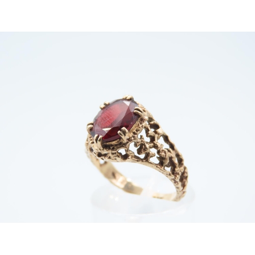 42 - 9 Carat Yellow Gold Red Garnet Set Centre Stone Ring Detailing to Shoulders Ring Size N