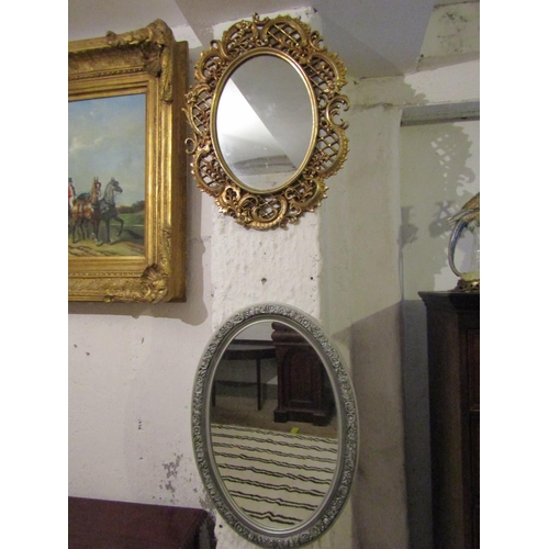 724 - Two Oval Form Wall Mirrors One Gilt Decorated Other Silvered Largest Approximately 22 Inches High