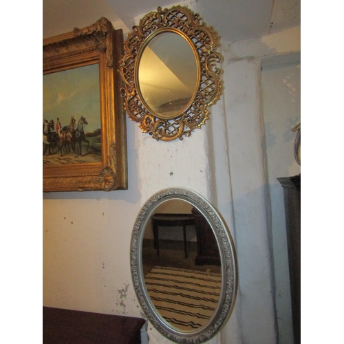 724 - Two Oval Form Wall Mirrors One Gilt Decorated Other Silvered Largest Approximately 22 Inches High