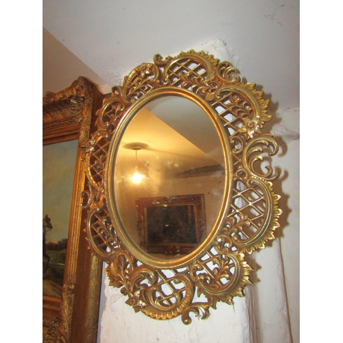 724 - Two Oval Form Wall Mirrors One Gilt Decorated Other Silvered Largest Approximately 22 Inches High