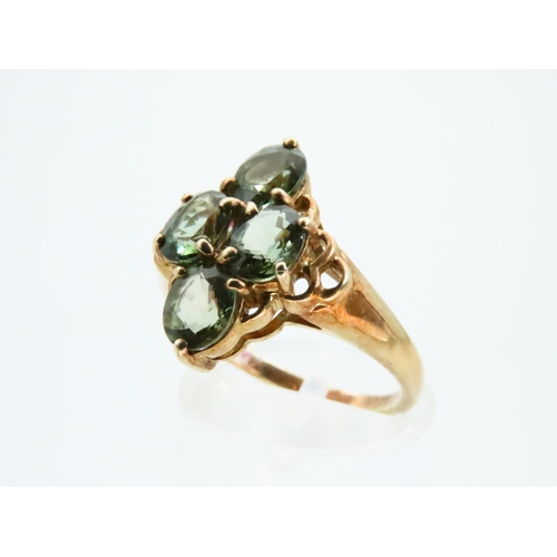 73 - Four Stone Peridot Ladies Ring Mounted on 9 Carat Yellow Gold Band Ring Size N and a Half