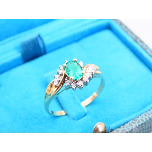 105 - Emerald and Diamond Ladies Cluster Ring with Further Diamond Decorated to Shoulders Mounted on 18 Ca... 