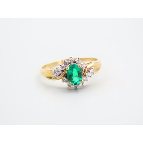 105 - Emerald and Diamond Ladies Cluster Ring with Further Diamond Decorated to Shoulders Mounted on 18 Ca... 