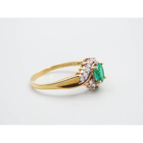 105 - Emerald and Diamond Ladies Cluster Ring with Further Diamond Decorated to Shoulders Mounted on 18 Ca... 