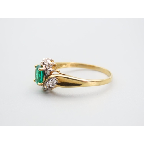 105 - Emerald and Diamond Ladies Cluster Ring with Further Diamond Decorated to Shoulders Mounted on 18 Ca... 