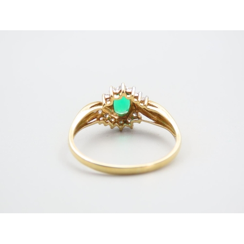 105 - Emerald and Diamond Ladies Cluster Ring with Further Diamond Decorated to Shoulders Mounted on 18 Ca... 