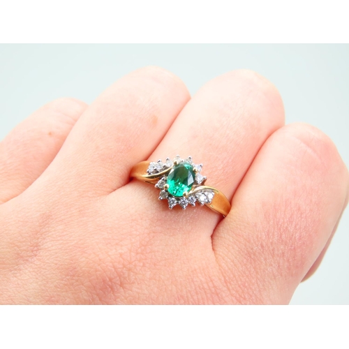 105 - Emerald and Diamond Ladies Cluster Ring with Further Diamond Decorated to Shoulders Mounted on 18 Ca... 