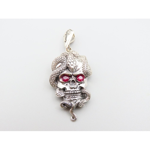 217 - Silver Skull and Serpent Motif Pendant with Ruby Inset Eyes 5cm High