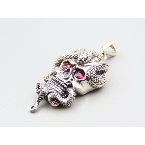 217 - Silver Skull and Serpent Motif Pendant with Ruby Inset Eyes 5cm High