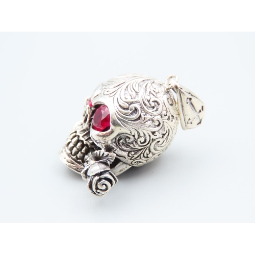 219 - Silver Skull and Rose Motif Pendant Ruby Set Eyes Incised Decoration Throughout 4cm High