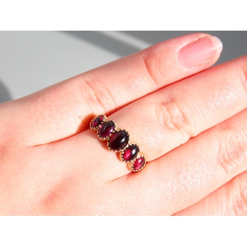 329 - Five Stone Cabochon Cut Polished Garnet Ring Mounted on 9 Carat Yellow Gold Band Ring Size P