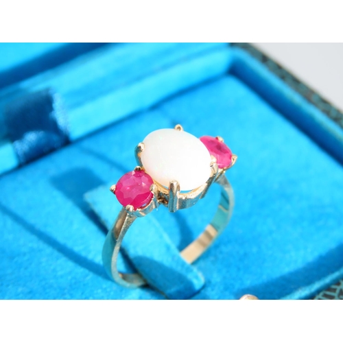 334 - Opal and Ruby Three Stone Ring Set on 9 Carat Yellow Gold Band Ring Size N