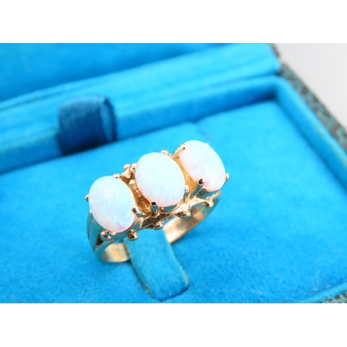 345 - Opal Three Stone Ring Mounted on 9 Carat Yellow Gold Band Ring Size O and a Half