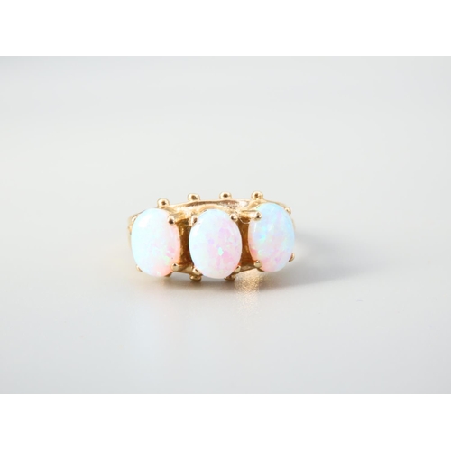 345 - Opal Three Stone Ring Mounted on 9 Carat Yellow Gold Band Ring Size O and a Half