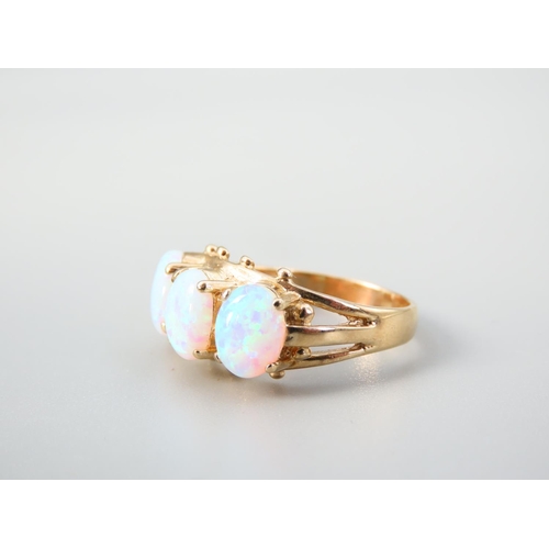 345 - Opal Three Stone Ring Mounted on 9 Carat Yellow Gold Band Ring Size O and a Half