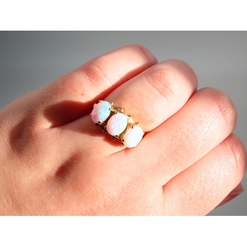 345 - Opal Three Stone Ring Mounted on 9 Carat Yellow Gold Band Ring Size O and a Half